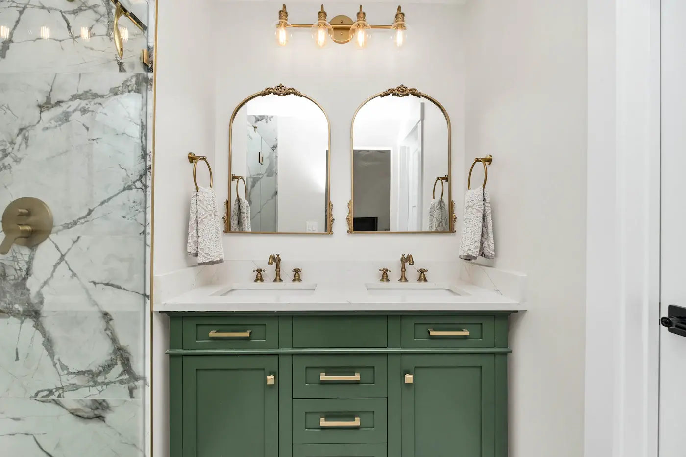 Bathroom with a green vanity and marble walls