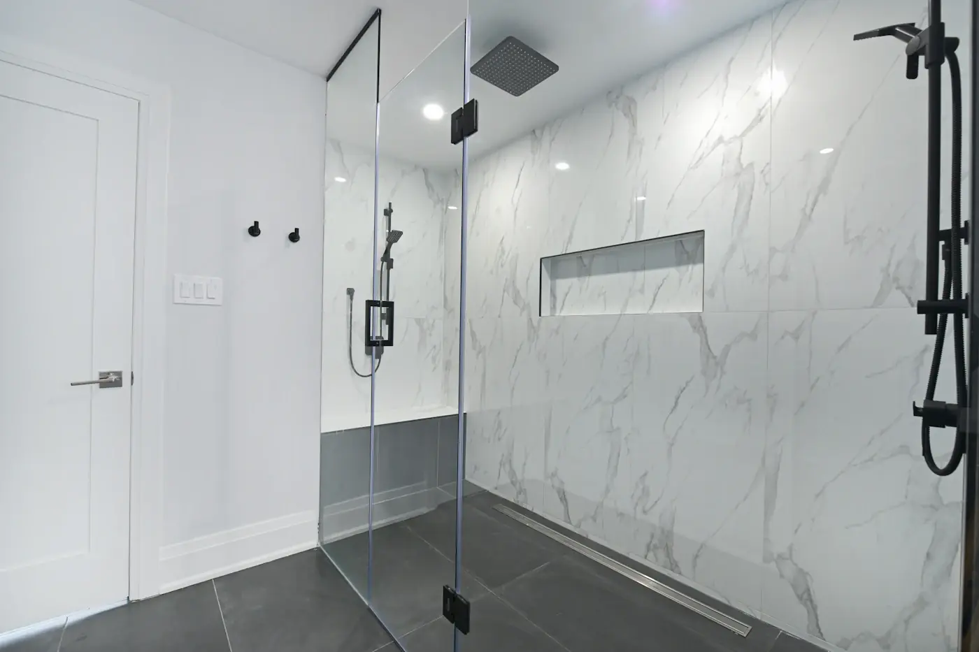 Walk-in shower with marble-look tiles