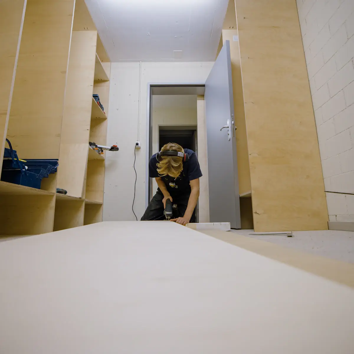 A carpenter fitting kitchen cabinets